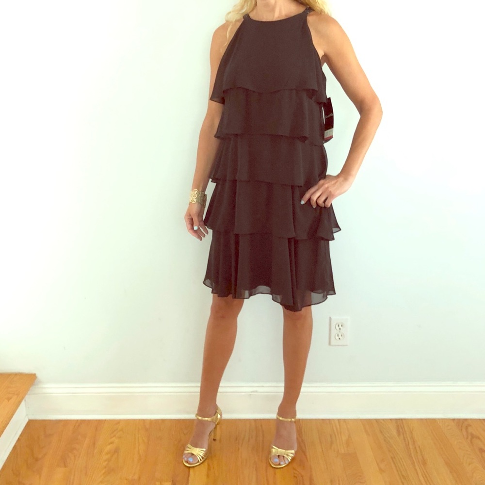 Black tiered cocktail dress with beaded straps.
